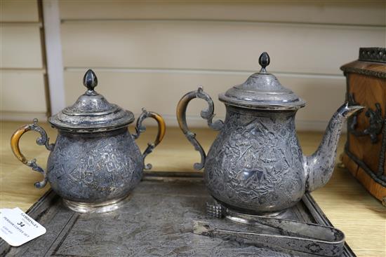 A four piece tea and coffee set with tongs